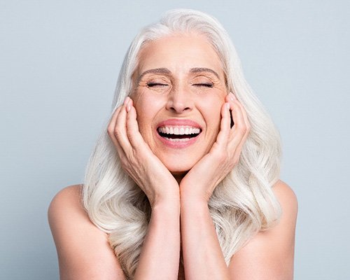 a patient smiling after receiving cosmetic dentistry