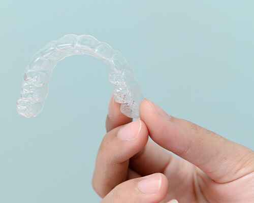 Patient holding clear aligner