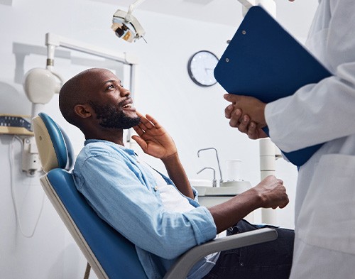 Male patient talking to dentist