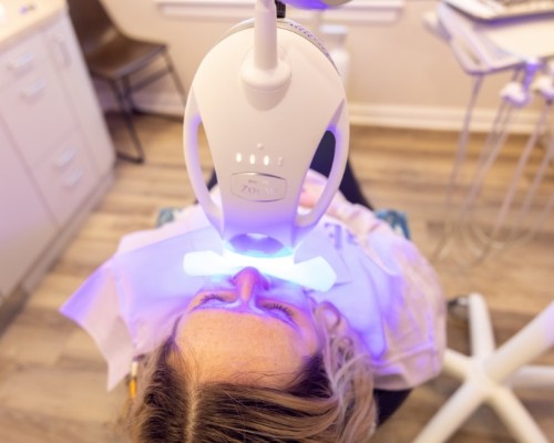 Woman receiving in office teeth whitening