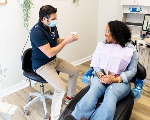 Dentist talking to a patient about the benefits of dental implants