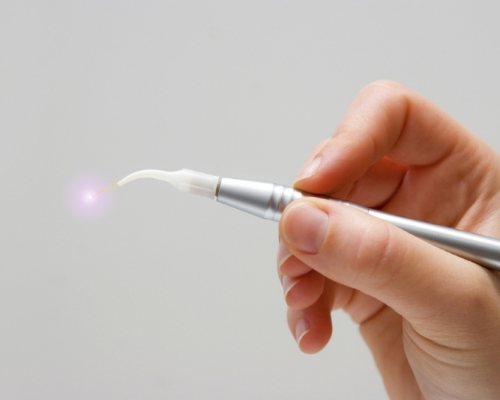 Soft tissue laser held in a person's hand