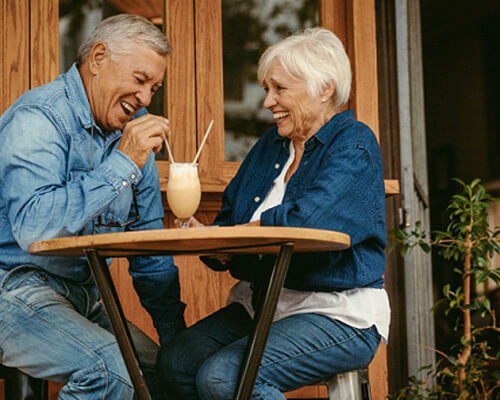 senior couple sharing a milkshake