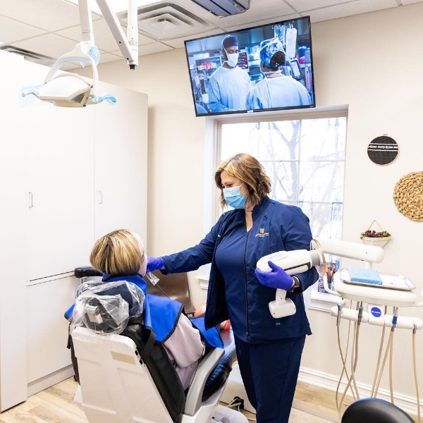 Jenks dental team member taking x rays of a dental patient