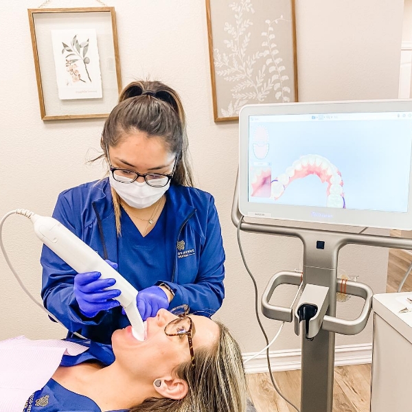 Jenks dental team member taking digital dental impressions of a patient