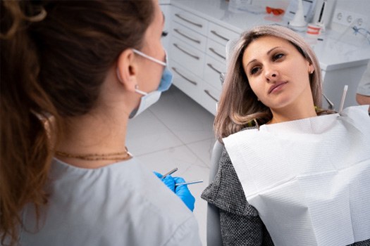 Patient in Glenpool holding cheek due to dental pain