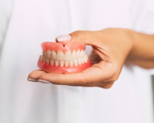 Dentist holding a set of full dentures
