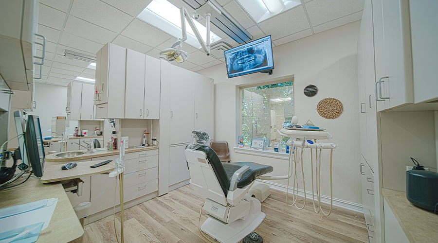 Dental treatment room with dental x rays on computer monitor