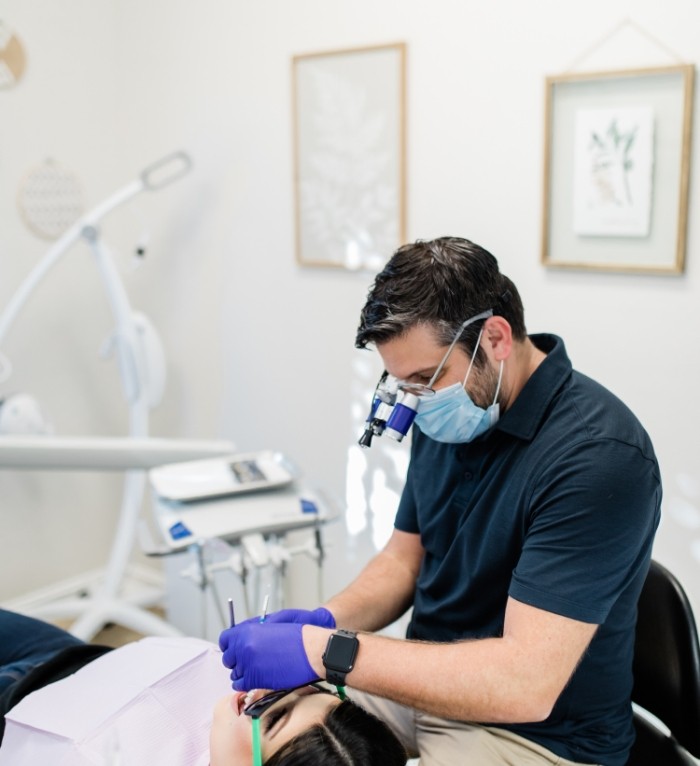 Doctor Salayta providing dental services in Jenks to a patient