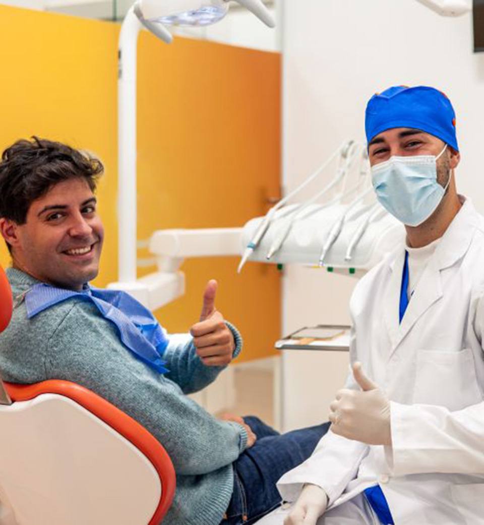 Patient and dentist making thumbs-up gesture