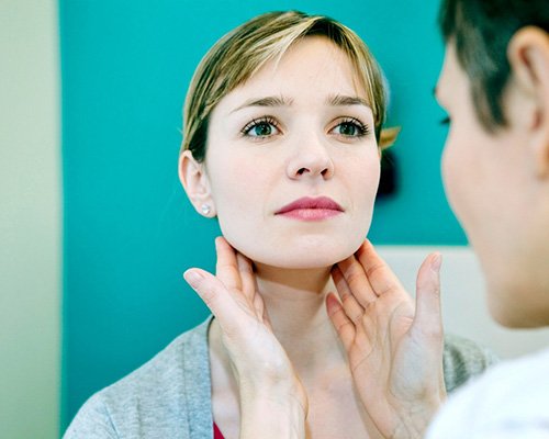 Dental team member checking patient’s lymph nodes