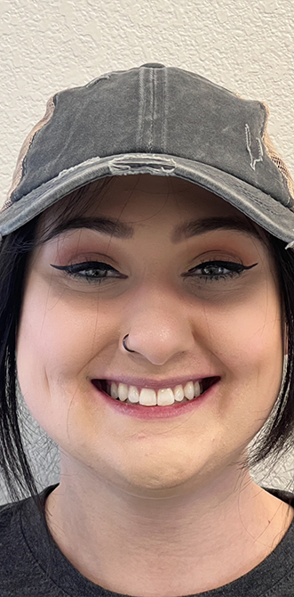 Smiling young woman with winged eyeliner and white teeth