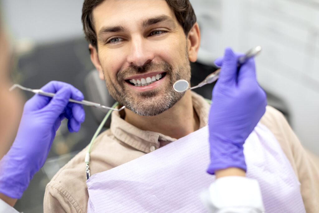 Man smiling at dentist about to perform oral exam